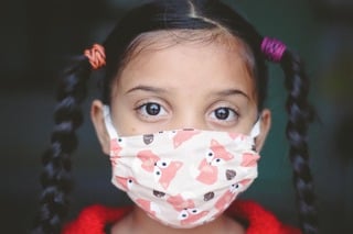 Young Girl Wearing A Colorful Mask